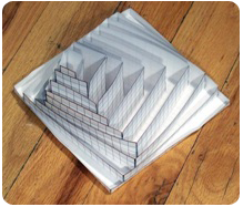 Nine nested paper boxes of progressively different shapes, used to teach volume by length × width × height